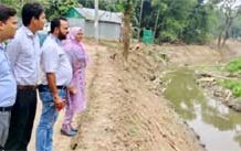 UNO and Project Implementation Officer inspect the re-excavation work of the Trishal catchment canal